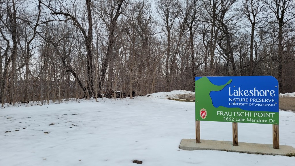 A sign marking the Frautschi Point entrance to the Lakeshore Nature Preserve in winter.