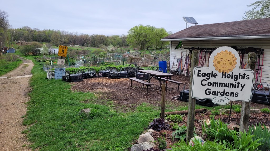 A sign marking the entrance to Eagle Heights Community Gardens in spring.